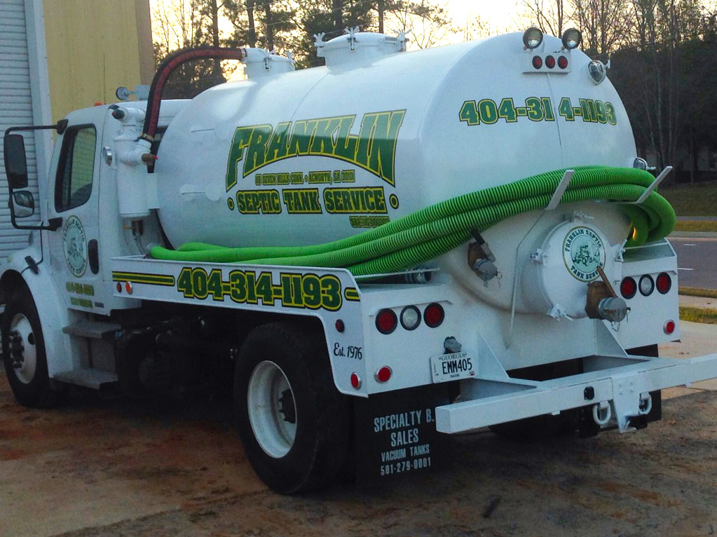 Franklin Septic Tank Service green pumping truck in the field